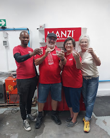 MANZI team and community members sharing prepared drinking water
